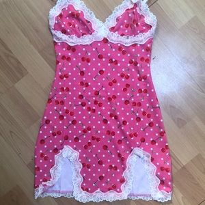 Pink bodycon dress with cherry pattern.